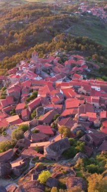 Sunset 'teki Monsanto Köyü. Portekiz. Hava görüntüsü. Drone yukarı ve geri hareket ediyor. Dikey Video