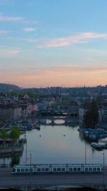 Zürih Şehri Eski Şehir ve Gündoğumunda Limmat Nehri. Altın Saat. İsviçre. Hava görüntüsü. Drone Yükseliyor. Dikey Video