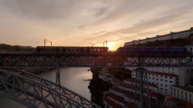 Porto Şehri, Douro Nehri ve Dom Luis Köprüsü I Sunrise 'da Tram ile. Pencereden bakan güneş ışığı. Portekiz. Renkli Gökyüzü. Altın Saat. Hava Aracı Atışı. Yan Taraflar Taşınıyor