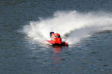 PESO DA REGUA, PORTUGAL - SEPTEMBER 15, 2024: Red Powerboat Makes Turn with Splashes of Water during Race. Formula 2 World Championship clipart