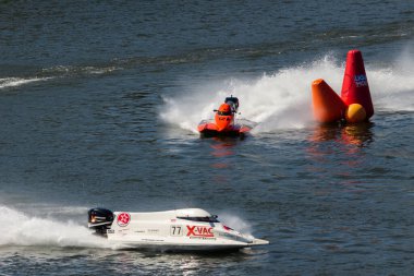 PESO DA REGUA, PORTUGAL - SEPTEMBER 15, 2024: Red and White Powerboats Go Fast with Splashes of Water during Race. Red Buoy. Formula 2 World Championship clipart