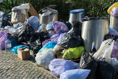 LISBON, PORTUGAL - DECEMBER 26, 2024: Uncollected Garbage Piling Up near Recycling Bins because of Workers Strike clipart