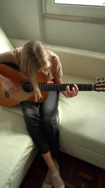 13 yaşında, evde gitar çalan genç bir kız. Dikey Video