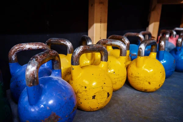 stock image Row of colorful kettlebells in gym. Equipment for sport exercises. Sport activity and healthy lifestyle concept