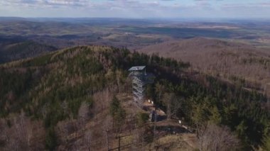 Orman ve turistler için gözlem kulesiyle kaplı dağların insansız hava aracı görüntüsü. Polonya 'da sonbahar mevsiminde dağlar ve vadiler, kuş bakışı manzara.