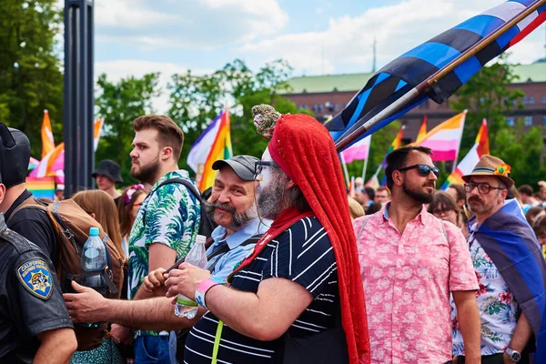 stock image Crowd of happy people marching at city street in Poland with rainbow flags. Pride parade for the support of sexual minorities. Wroclaw, Poland - June 11, 2022