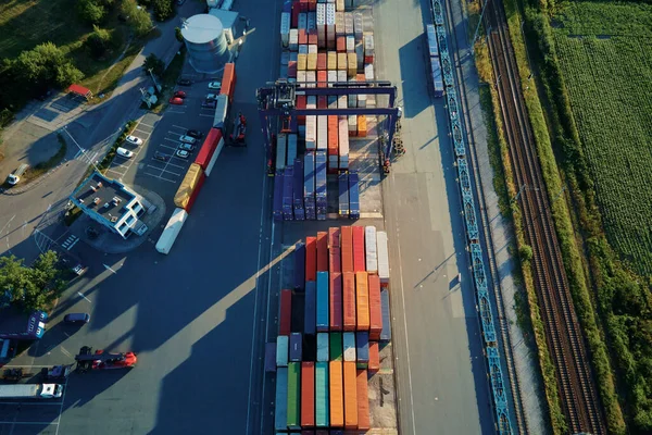 Shipping container site in warehouse storage factory, aerial view. Business and logistic concept, cargo transit