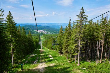 Ski lift in mountains. Karpacz resort in Poland with lift road. Mountain hiking and active vacation