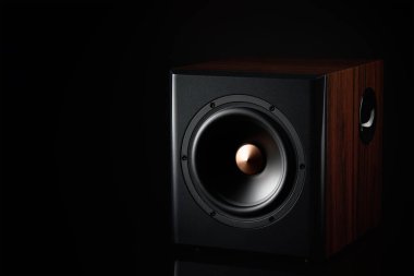 Sound speaker on dark background with copy space. Set for listening music. Audio subwoofer