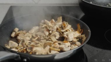 Champignons mushrooms are fried in frying pan. Cooking process