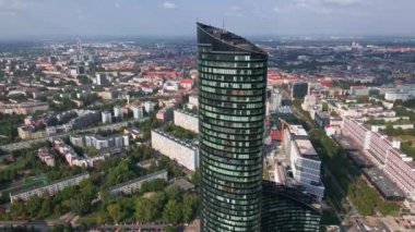 Drone flight over skyscraper. Modern office building, aerial view. Cityscape panorama with business center glass facade in Wroclaw, Poland