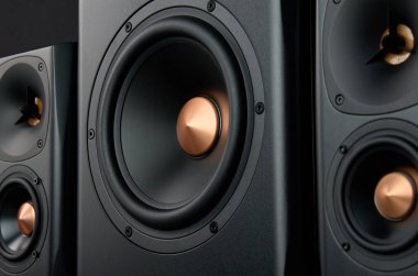 Two sound speakers and subwoofer on dark background. Set for listening music. Audio equipment