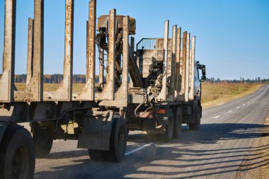 Kırsal yolda römorklu boş tomruk kamyonu görünümü
