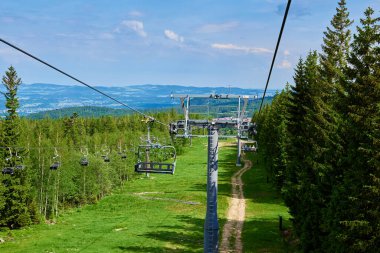Ski lift in mountains. Karpacz resort in Poland with lift road. Mountain hiking and active vacation