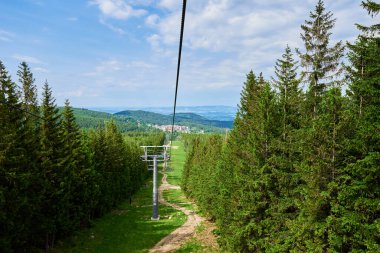 Ski lift in mountains. Karpacz resort in Poland with lift road. Mountain hiking and active vacation