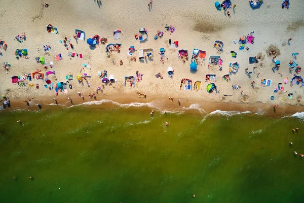 stock image Aerial view of sea landscape with crowded sand beach in Wladyslawowo. Baltic sea coastline with swimming people in Poland. Resort town in summer season