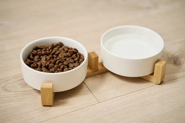 Bowls of dog food and water on kitchen floor, Animal feeding and pet care, Place to feed a pet