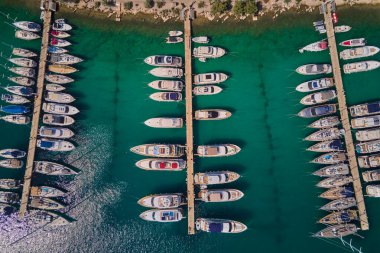Hırvatistan 'ın Rogoznica kentindeki Frapa marinasına güneşli yaz gününde lüks yatlar ve yelkenliler yanaşıyor. Adriyatik Denizi, Dalmaçya bölgesinde yaz tatili için turistik bir şehir. Yaz tatili kavramı