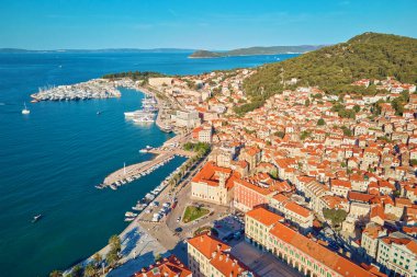 Aerial view of Split, Croatia. Cityscape of coastal touristic city with harbor. Old town with historical red roof tiled buildings near Adriatic Sea clipart