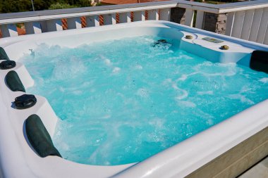 Close-up shot bubbling water in hot tub with headrests clipart