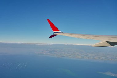 Uçak penceresinden uçak kanadının görüntüsü. Hava yolculuğu ve uçuş konsepti