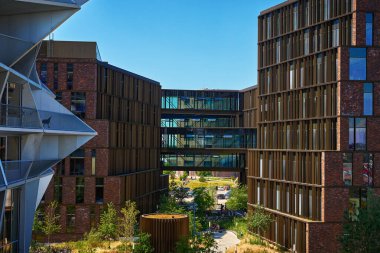 Danimarka, Kopenhag 'da bir yerleşim bölgesi. Modern şehir mimarisi, modern ofis binaları ve yürüyen insanlar. Kopenhag, Danimarka - 26 Haziran 2024