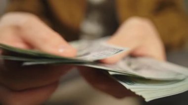 Adam Amerikan dolarlarını sayıyor. Kapatın. Nakit tasarruflar ve finansal zenginlik kavramı