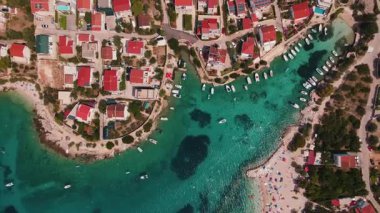 Sahil boyunca demirlemiş küçük tekneleri olan kıyı köyünün havadan görüntüsü. Hırvatistan 'ın Adriyatik Denizi kıyısındaki Rogoznica turizm kasabası. Yaz yolculuğu konsepti