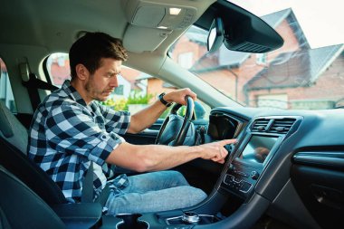 Adam arabada oturuyor ve motoru çalıştırma düğmesine basıyor. Modern ateşleme teknolojisini kullanarak aracı çalıştırıyorum. Arabayı sürmeye hazır olan kişi