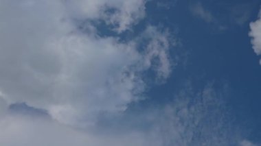 Gün ışığında dağınık bulutları hareket ettiren mavi gökyüzünün zamanı. Atmosfer koşulları ve değişen hava konsepti