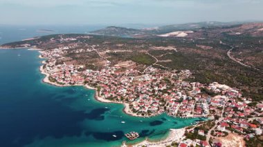Eğri kıyı şeridi boyunca uzanan Akdeniz kasabasının havadan çekilmiş fotoğrafı. Adriyatik kıyı şeridi, sahile yakın evler ve sakin deniz. Rogoznica, Hırvatistan
