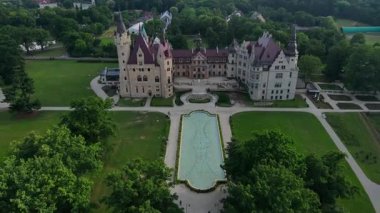 Moszna castle near Opole in Poland. Aerial view of historic castle surrounded by green park. European heritage and architecture