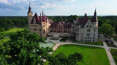 Moszna castle near Opole in Poland. Aerial view of historic castle surrounded by green park. European heritage and architecture