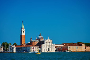 San Giorgio Maggiore kilisesi ve Venedik lagünündeki tarihi binaların bulunduğu bir adada çan kulesi. Seyahat, turizm ve İtalyan kültür mirası kavramı. Venedik, İtalya - 26 Ağustos 2025