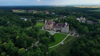 Moszna castle near Opole in Poland. Aerial view of historic castle surrounded by green park. European heritage and architecture