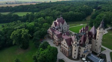 Moszna castle near Opole in Poland. Aerial view of historic castle surrounded by green park. European heritage and architecture