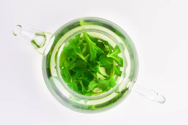 stock image Mint tea with fresh mint leaves in a glass teapot. Flat lay.