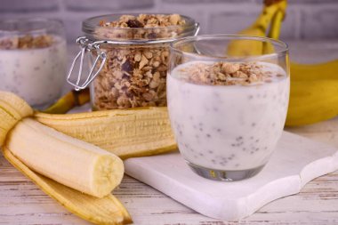 Banana chiapudding with granola. Healthy snack.