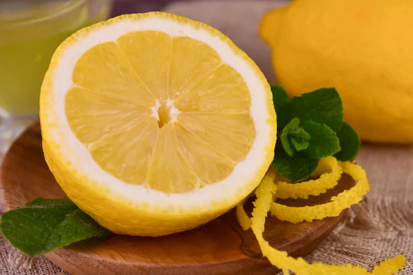 stock image Half a fresh lemon and lemon zest. Close-up.