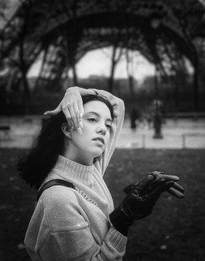 Lady near Eiffel Tower in Paris, France was made in winter. No snow, only some rain on the street. 
