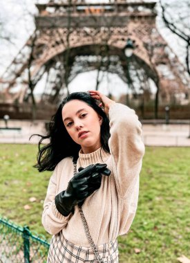Lady near Eiffel Tower in Paris, France was made in winter. No snow, only some rain on the street. 