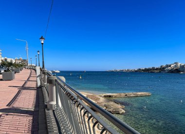 Panoramic view of the sea and the promenade in Bugibba, Malta clipart