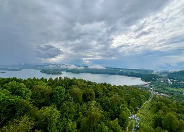 stock image Lake Solina is a largest in Poland water reservoir surrounded by a characteristic landscape of mountains covered with forest and plenty of beaches with tourist infrastructure.