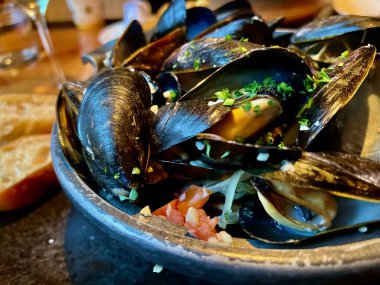 Restorandaki ahşap tabakta limonlu ve maydanozlu midyeler