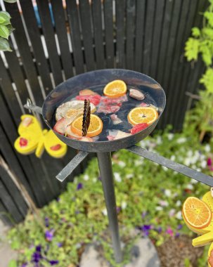 Butterfly on a plate with fresh fruit in the garden. clipart