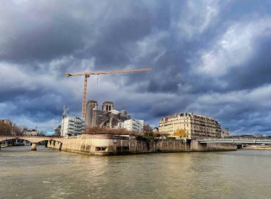 Paris, Fransa 'da Seine nehrinin üzerinde dramatik bir gökyüzü. Tekneden şehre bak.