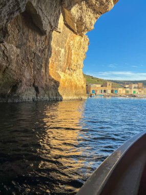 View from the boat  to the cave on the coast of the island of Gozo in Malta clipart