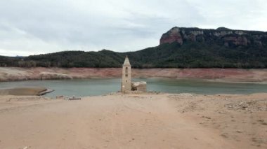 Kuru su deposundaki kilise. Katalonya, İspanya 'daki kurumuş rezervuar Sau. Kuraklık. İklim değişikliği kuraklık kara ve su rezervuarında, insansız hava aracı görünümü