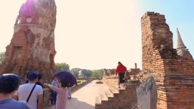16 Aralık 2019 - Wat Mahathat, Ayutthaya, Tayland - Harabelerde poz veren küçük bir grup turistin zaman aşımı.