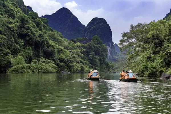 Rowing boats carrying tourists on the river in Trang An, Ninh Binh province, Vietnam. Trang An is a world cultural and natural heritage recognized by UNESCO